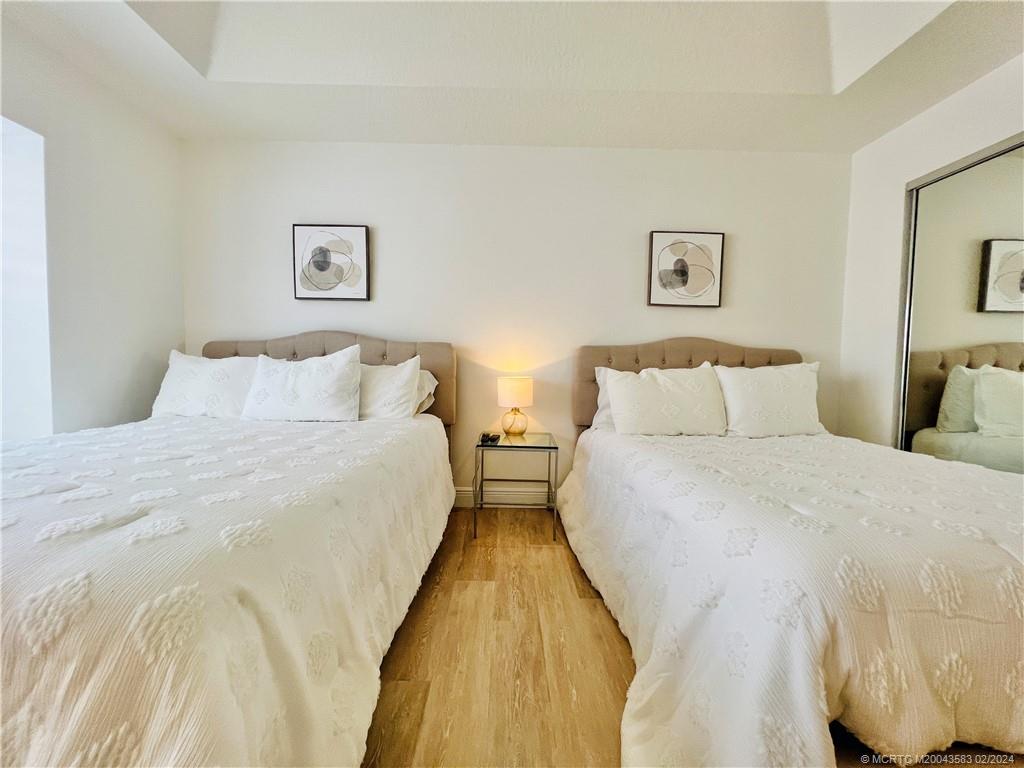 411 Northeast Plantation Road, Unit 526 Stuart, FL 34996 - Photo 39 of 76 a bedroom with bed and night stand