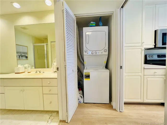a large white bathroom with a large tub and sink