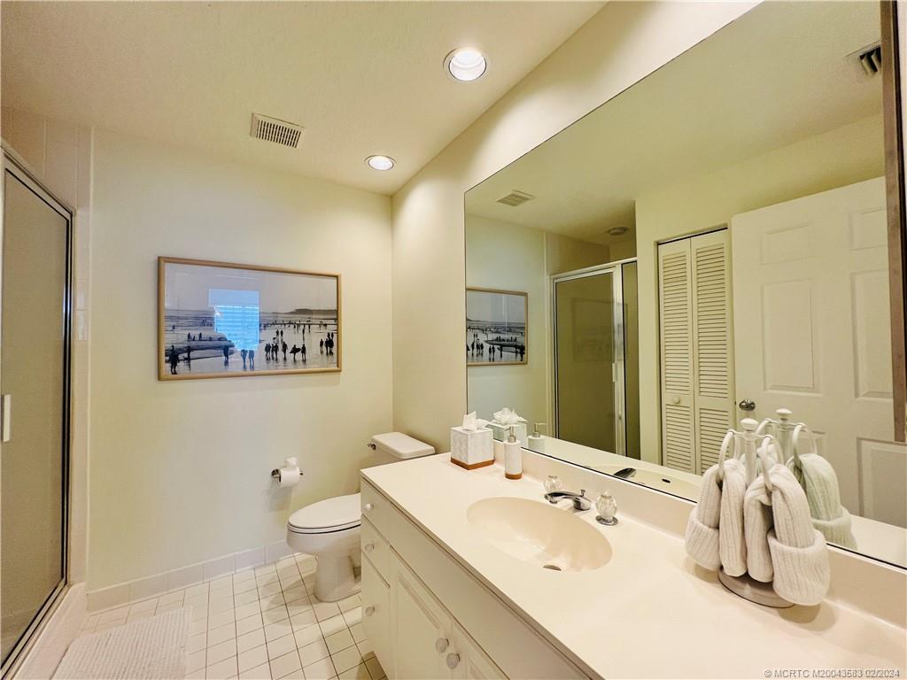 411 Northeast Plantation Road, Unit 526 Stuart, FL 34996 - Photo 43 of 76 a bathroom with a sink a toilet and a large mirror