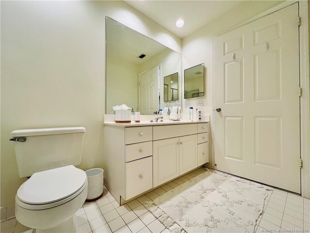 411 Northeast Plantation Road, Unit 526 Stuart, FL 34996 - Photo 46 of 76 a bathroom with a sink a toilet and mirror