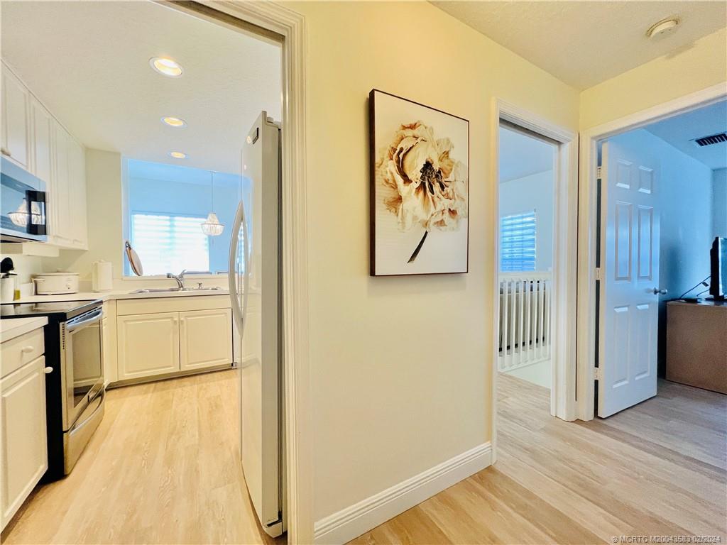 411 Northeast Plantation Road, Unit 526 Stuart, FL 34996 - Photo 48 of 76 a kitchen with a refrigerator and a stove