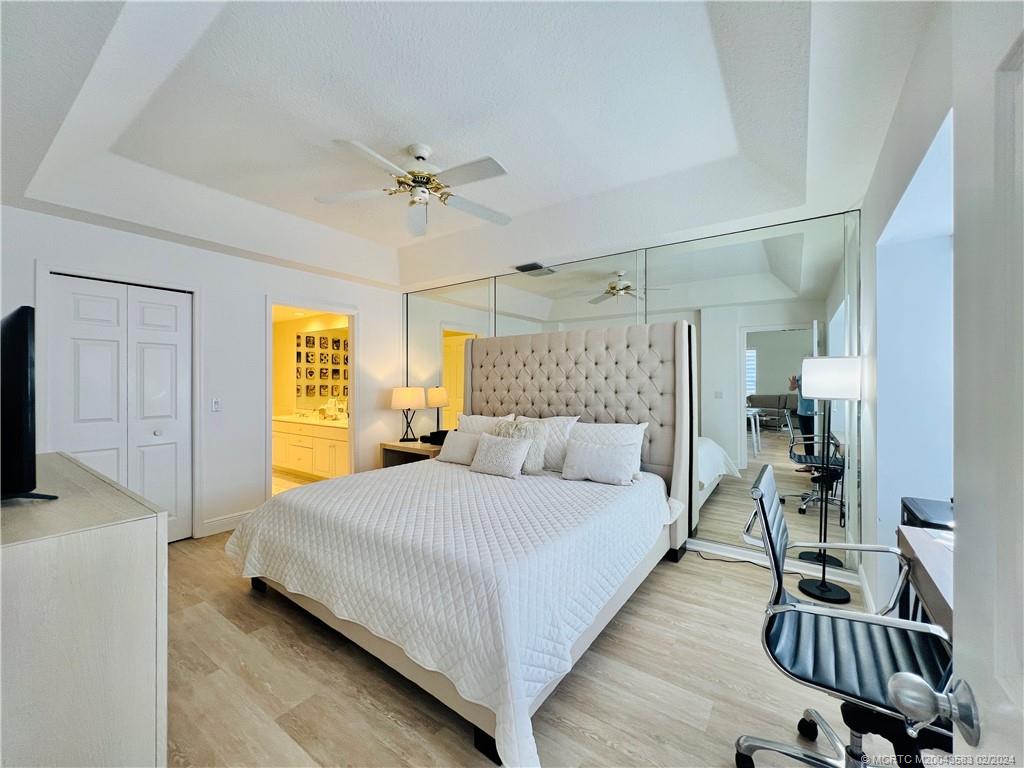 411 Northeast Plantation Road, Unit 526 Stuart, FL 34996 - Photo 49 of 76 a bedroom with a bed and a table in it