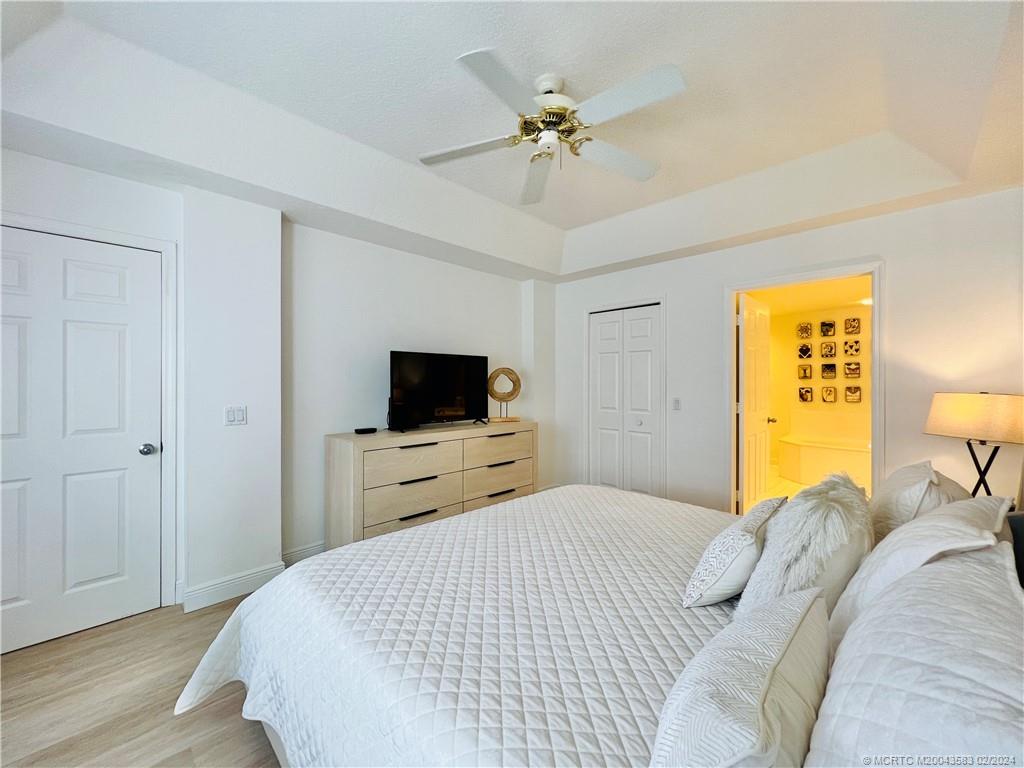 411 Northeast Plantation Road, Unit 526 Stuart, FL 34996 - Photo 51 of 76 a bedroom with a bed and a flat screen tv