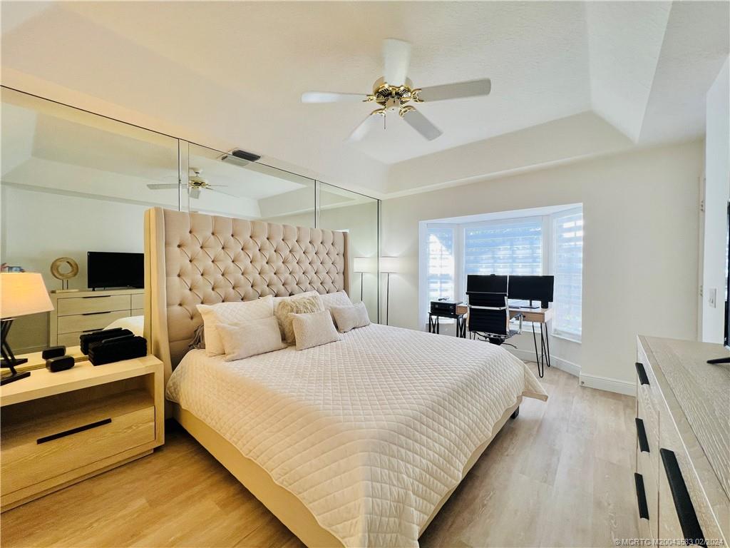 411 Northeast Plantation Road, Unit 526 Stuart, FL 34996 - Photo 52 of 76 a bedroom with a bed and a flat screen tv