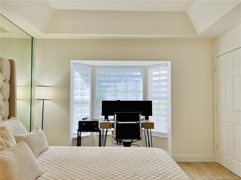 411 Northeast Plantation Road, Unit 526 Stuart, FL 34996 - Photo 54 of 76 a bedroom with a bed and a table