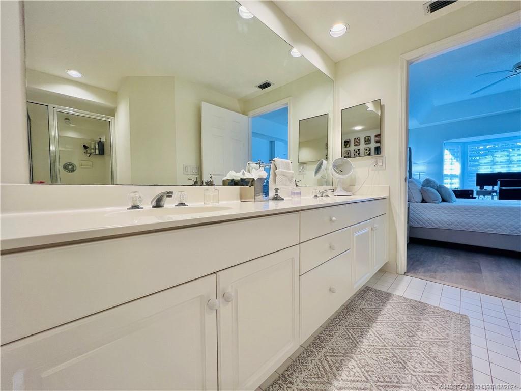 411 Northeast Plantation Road, Unit 526 Stuart, FL 34996 - Photo 62 of 76 a en suite bathroom with double sink and a large mirror