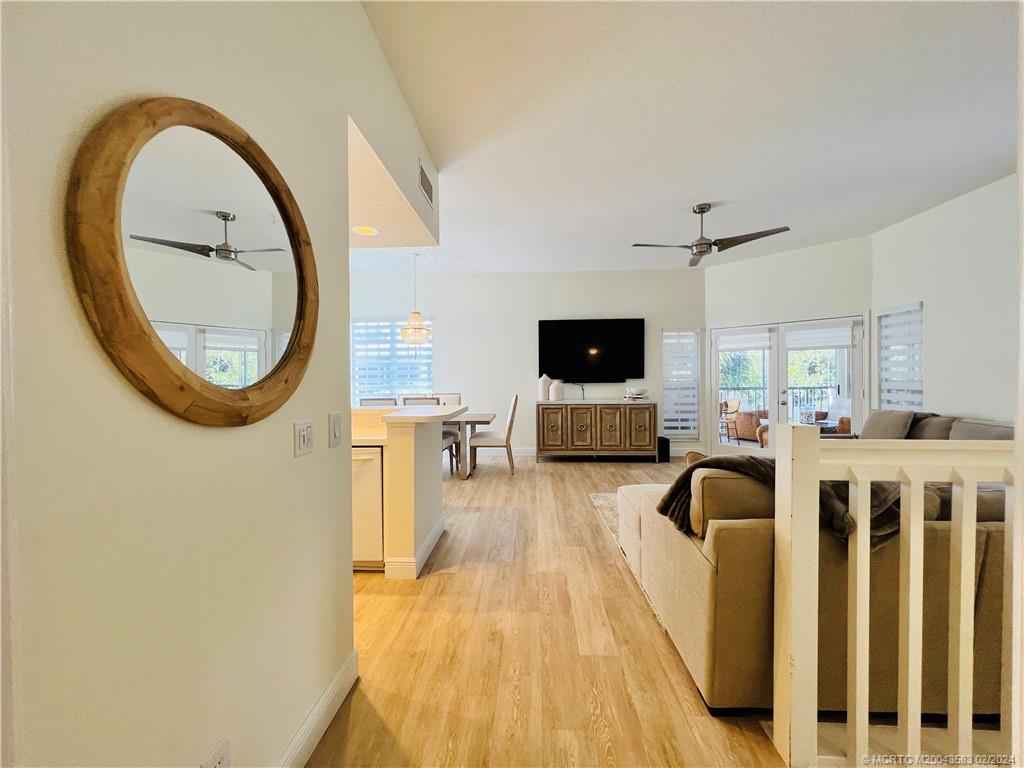 411 Northeast Plantation Road, Unit 526 Stuart, FL 34996 - Photo 7 of 76 a view of a livingroom with furniture and a flat screen tv