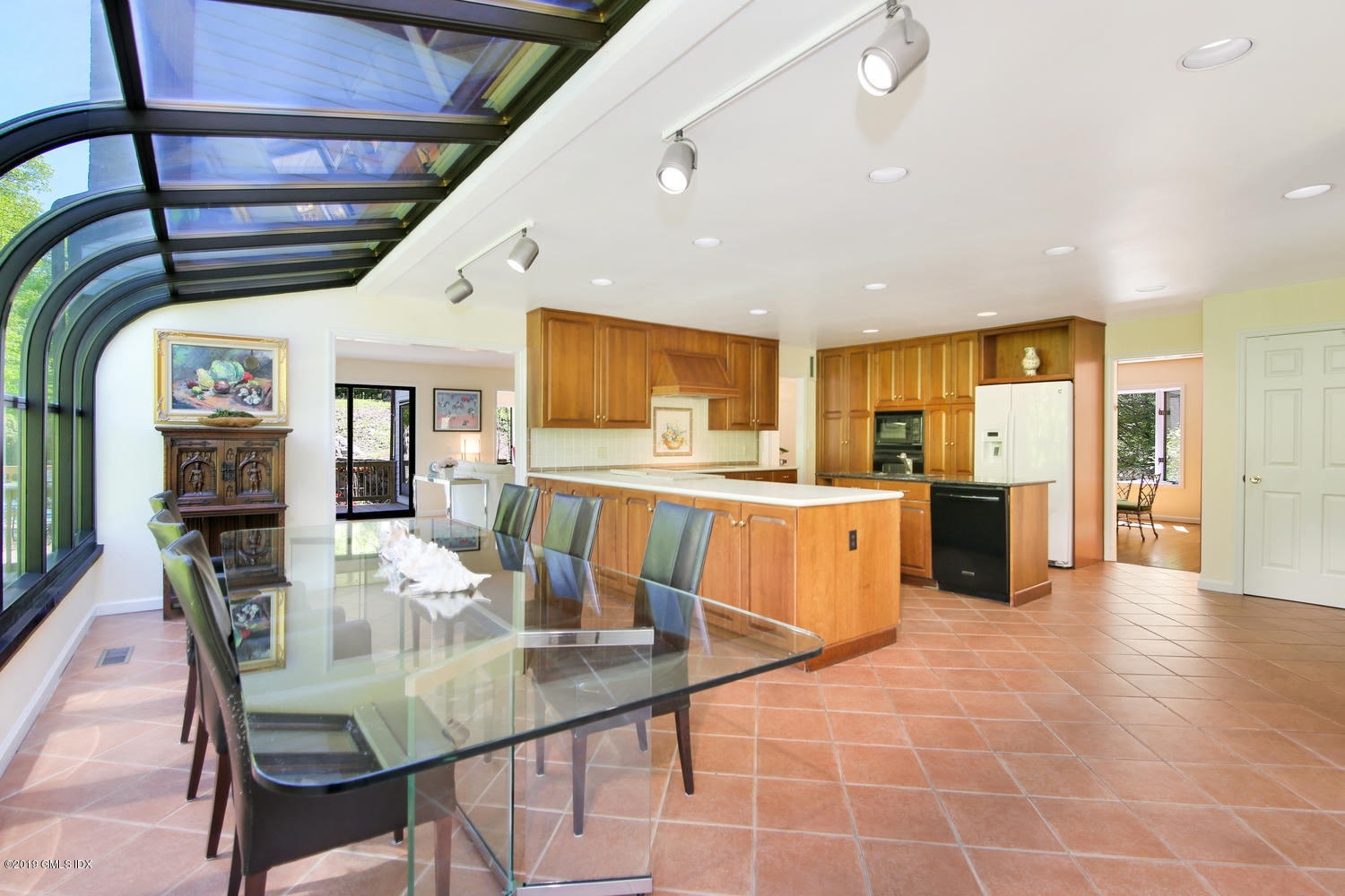 33 Ferncliff Road Cos Cob, CT 06807 - Photo 8 of 22 a kitchen with stainless steel appliances kitchen island granite countertop a table chairs and a refrigerator
