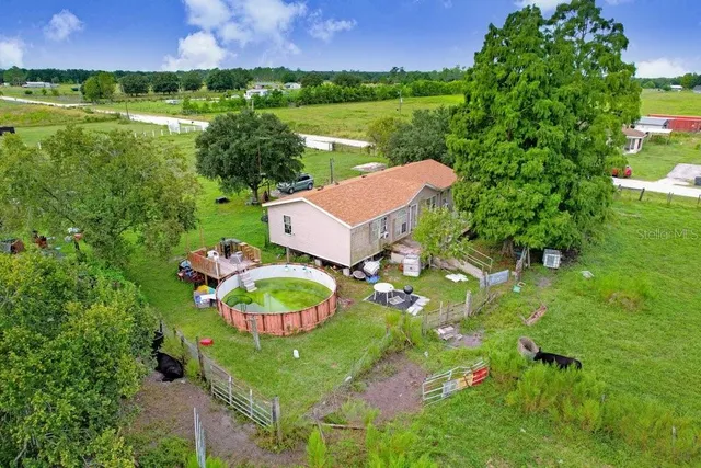 an aerial view of a house with outdoor space swimming pool and outdoor seating