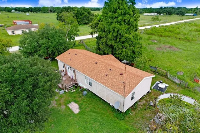 an aerial view of a house having yard