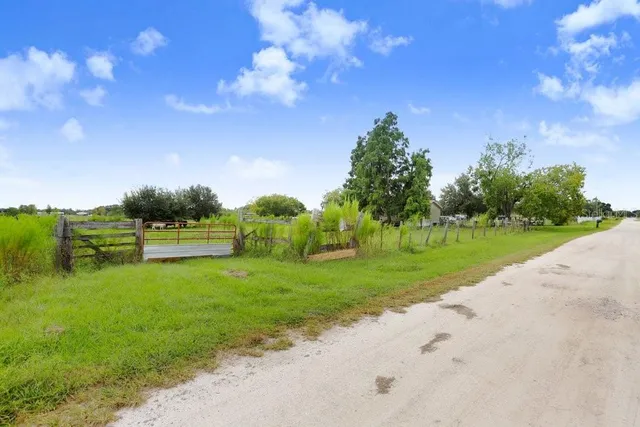 a backyard of a house with lots of green space and garden