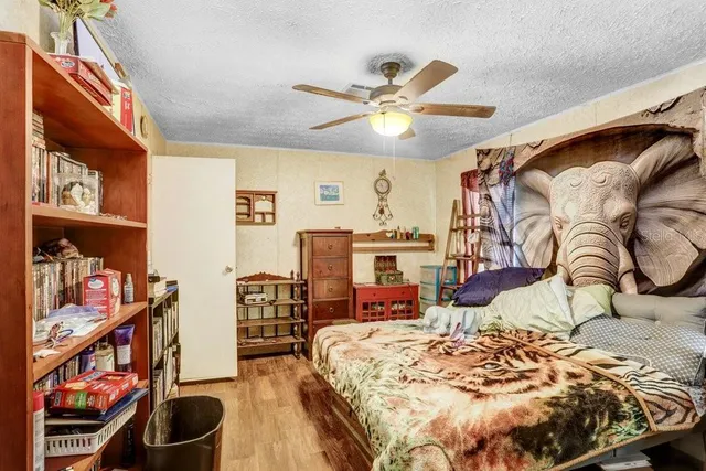 a bedroom with a large bed and a chandelier
