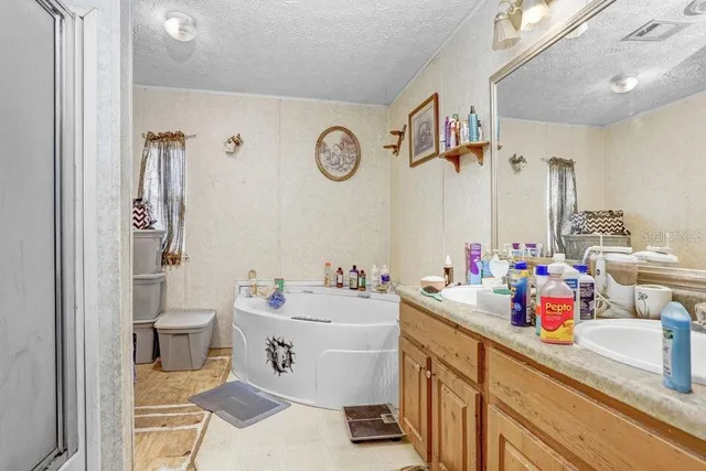 a bathroom with a sink mirror vanity and toilet