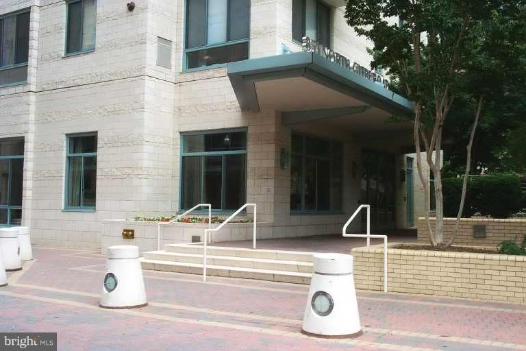 a view of pool with two chair and tables