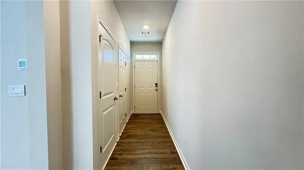 a view of a hallway with a white walls