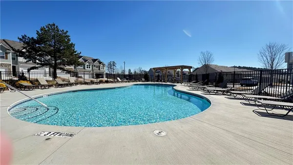 a swimming pool view with a outdoor seating