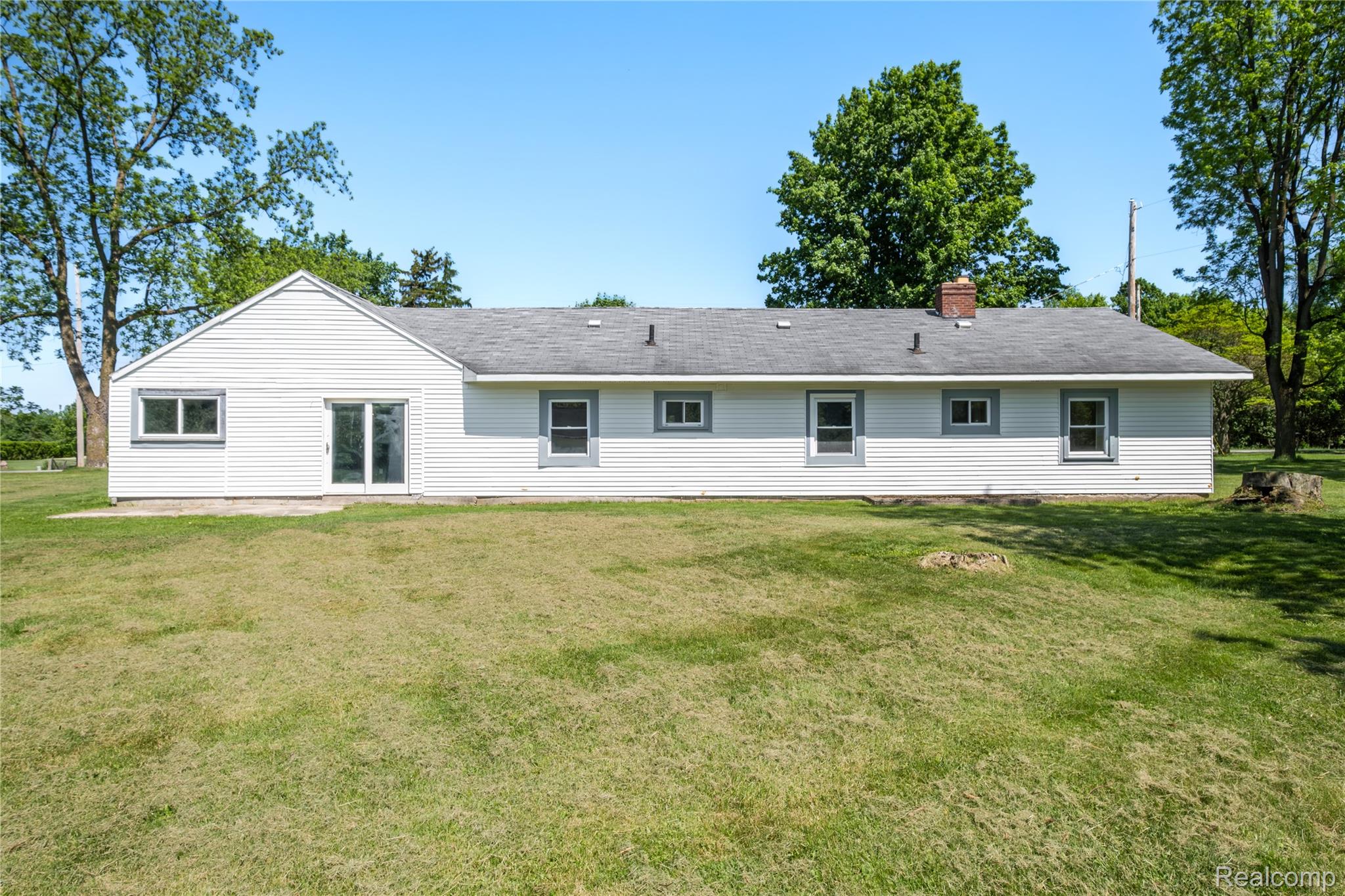12238 Jennings Road Linden, MI 48451 - Photo 25 of 33 Rear elevation featuring white siding and multiple windows