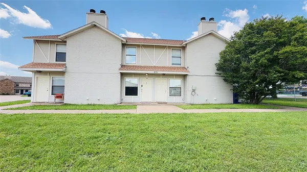 a view of a house with a yard and a garage