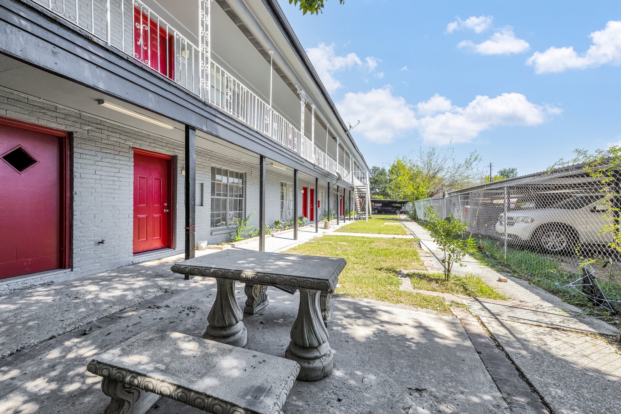 a view of a swimming pool with two chairs in a patio