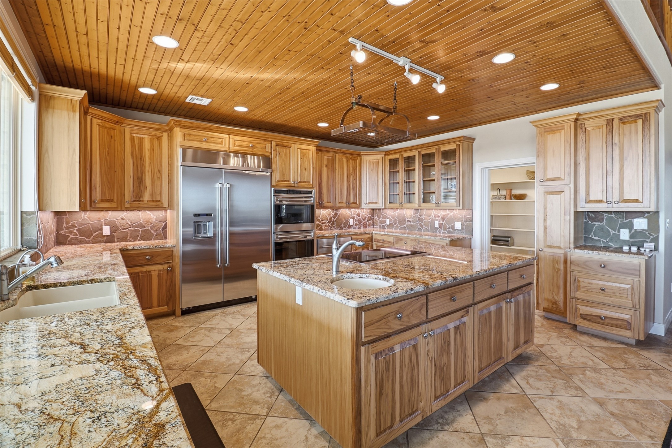 450 Threadgill Ranch Road Burnet, TX 78611 - Photo 6 of 33 a kitchen with stainless steel appliances granite countertop a sink stove and refrigerator
