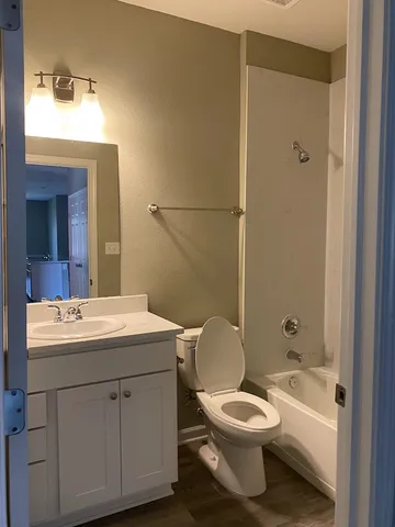 a bathroom with a toilet a sink and mirror