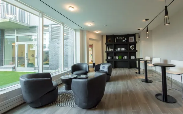 a living room with furniture and a dining table