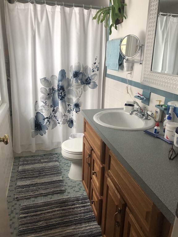 74 Old Stage Road Chelmsford, MA 01824 - Photo 14 of 33 a bathroom with a sink a toilet and a mirror
