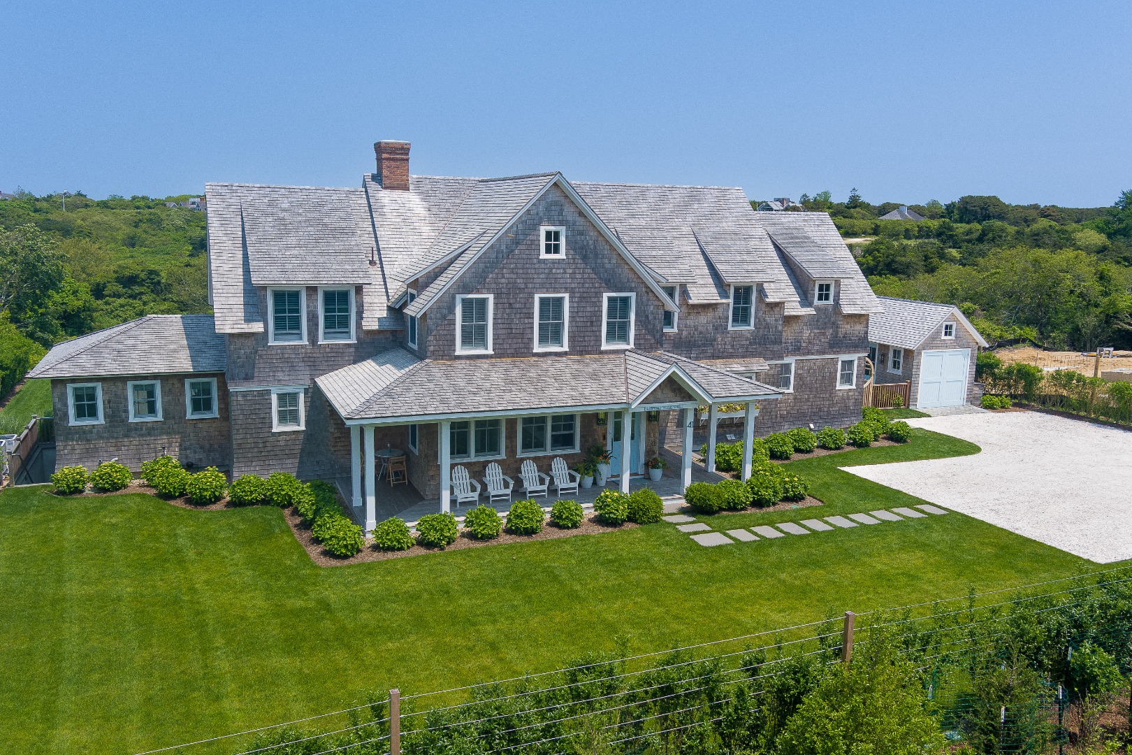 41 Monomoy Road Nantucket, MA 02554 - Photo 2 of 54 a front view of a house with a yard