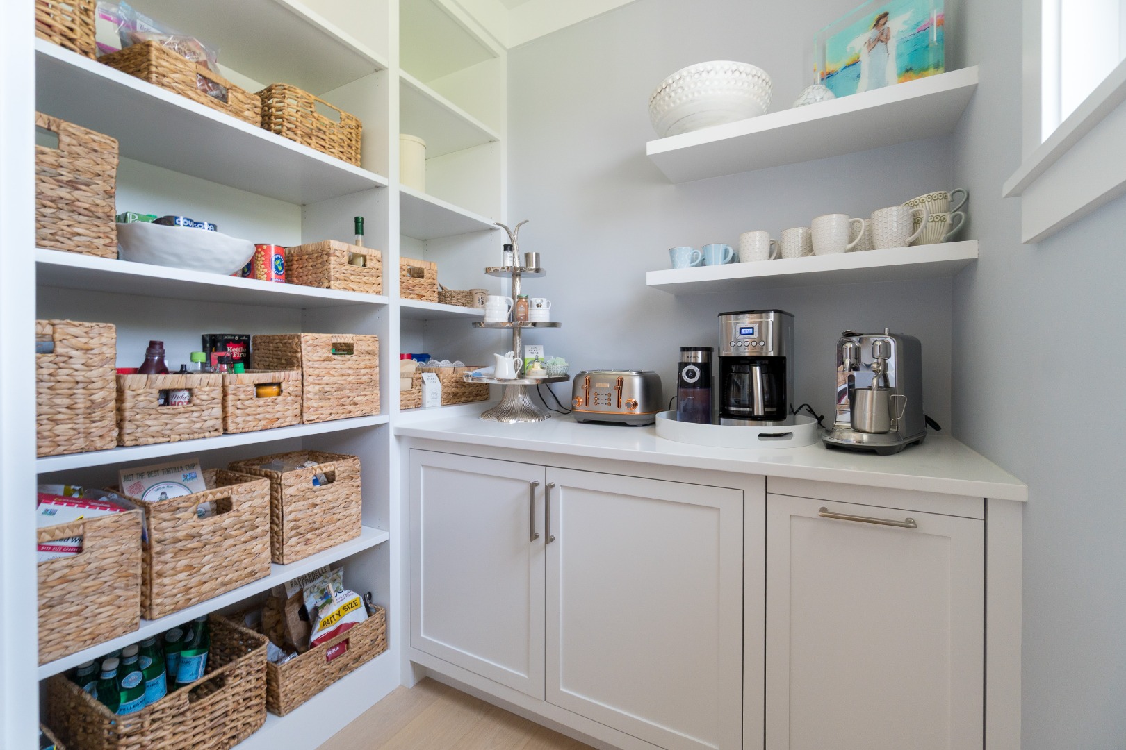 41 Monomoy Road Nantucket, MA 02554 - Photo 28 of 54 a kitchen with white cabinets and a wooden floor