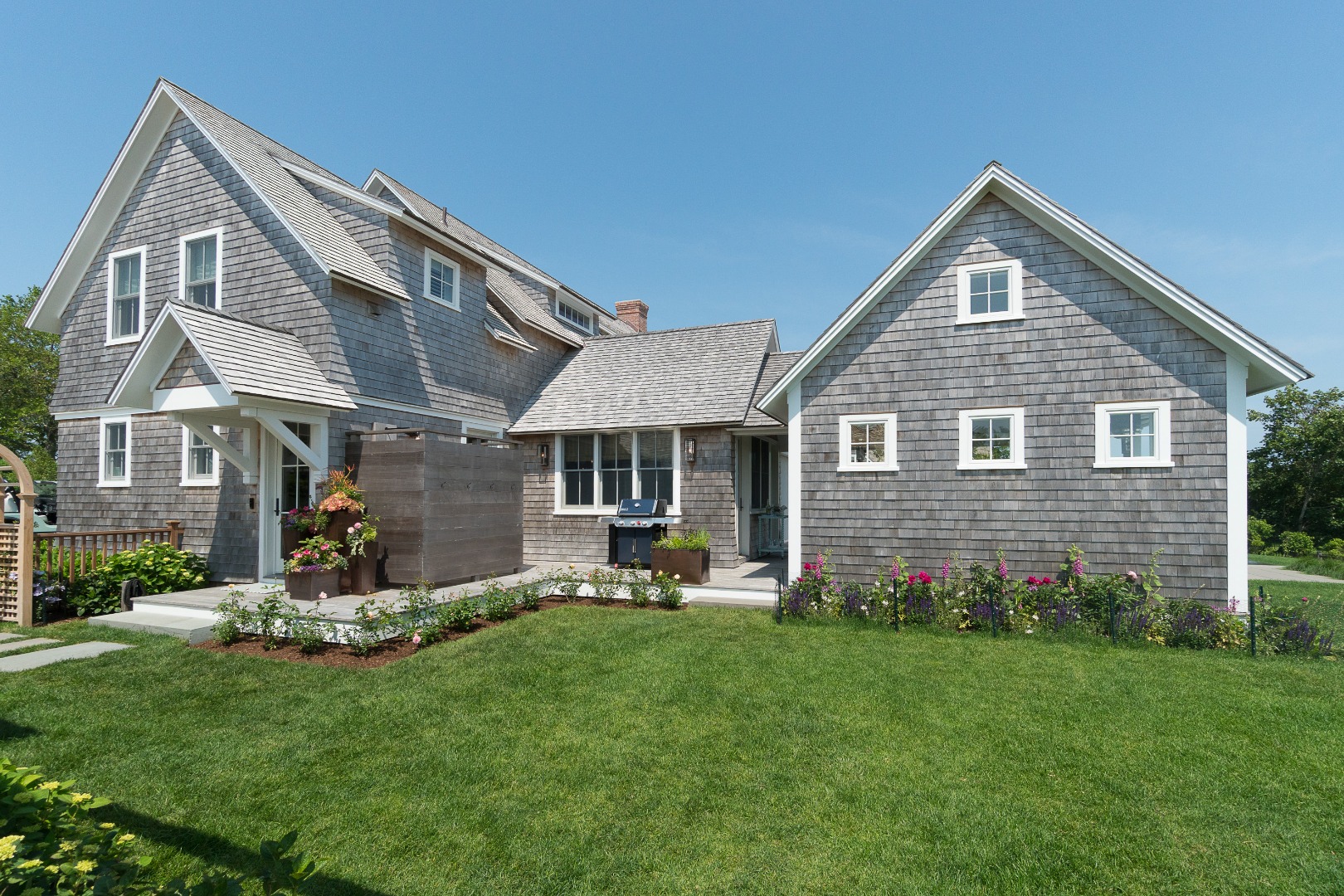41 Monomoy Road Nantucket, MA 02554 - Photo 4 of 54 a front view of a house with a yard and garage