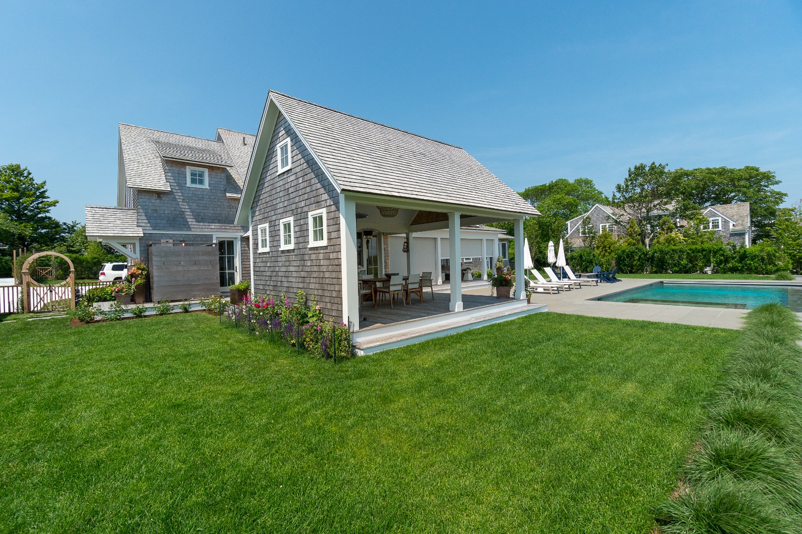 41 Monomoy Road Nantucket, MA 02554 - Photo 7 of 54 a view of a house with a backyard porch and sitting area