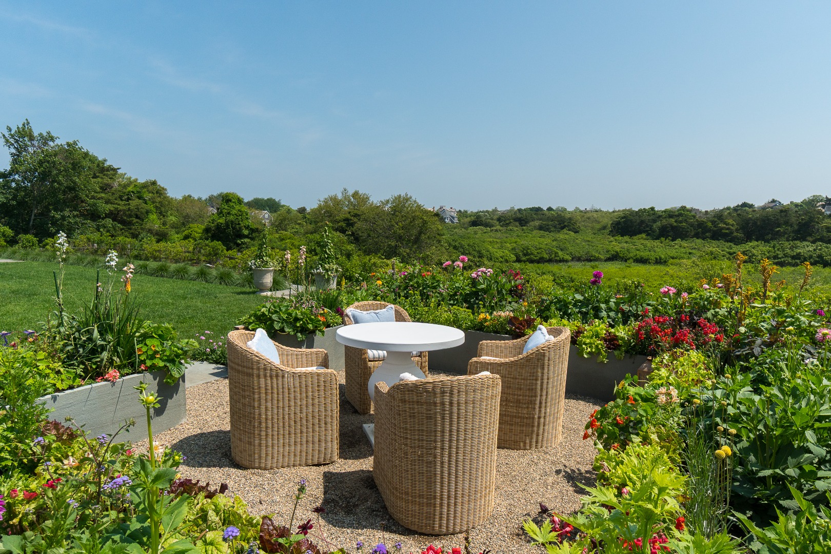 41 Monomoy Road Nantucket, MA 02554 - Photo 10 of 54 a view of a garden with plants and a lake view