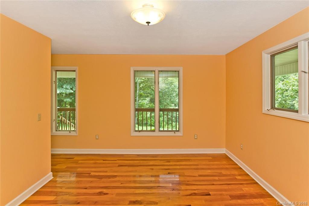 282 Fox Creek Road Mars Hill, NC 28754 - Photo 11 of 36 a view of an empty room with wooden floor and a window