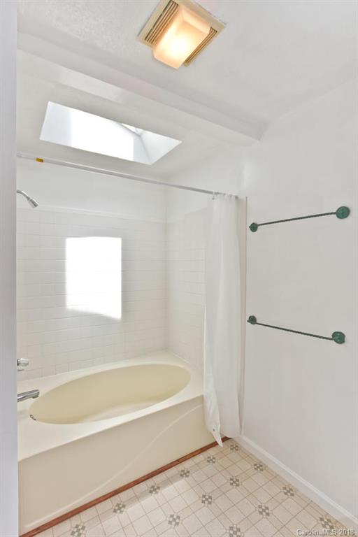 282 Fox Creek Road Mars Hill, NC 28754 - Photo 19 of 36 a bathroom with a bathtub and a shower