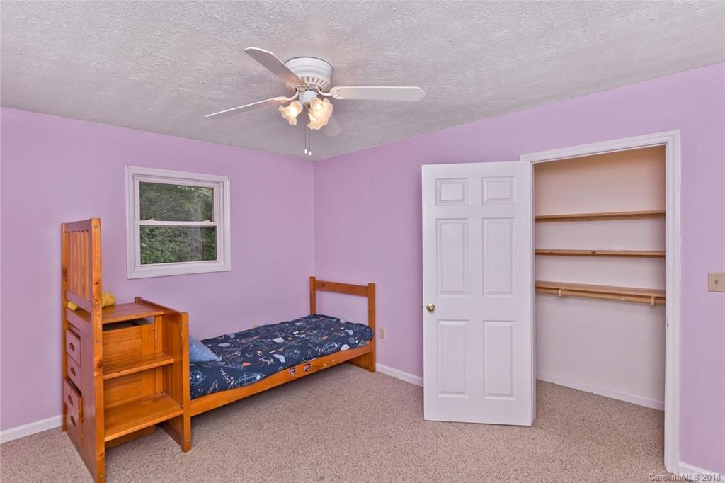 282 Fox Creek Road Mars Hill, NC 28754 - Photo 20 of 36 a bedroom with a bed and a window