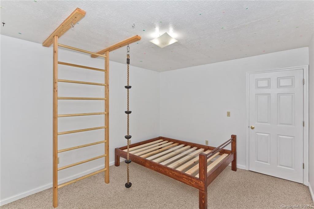 282 Fox Creek Road Mars Hill, NC 28754 - Photo 21 of 36 a room with a bunk bed and a dresser