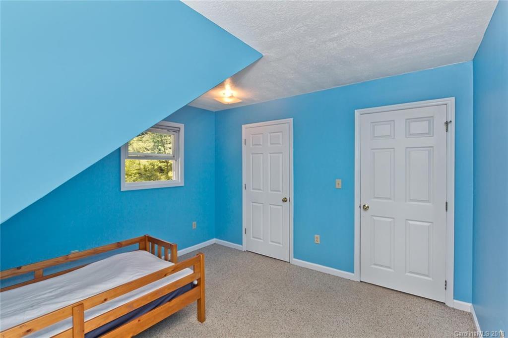 282 Fox Creek Road Mars Hill, NC 28754 - Photo 25 of 36 a room with a bed and a bookshelf