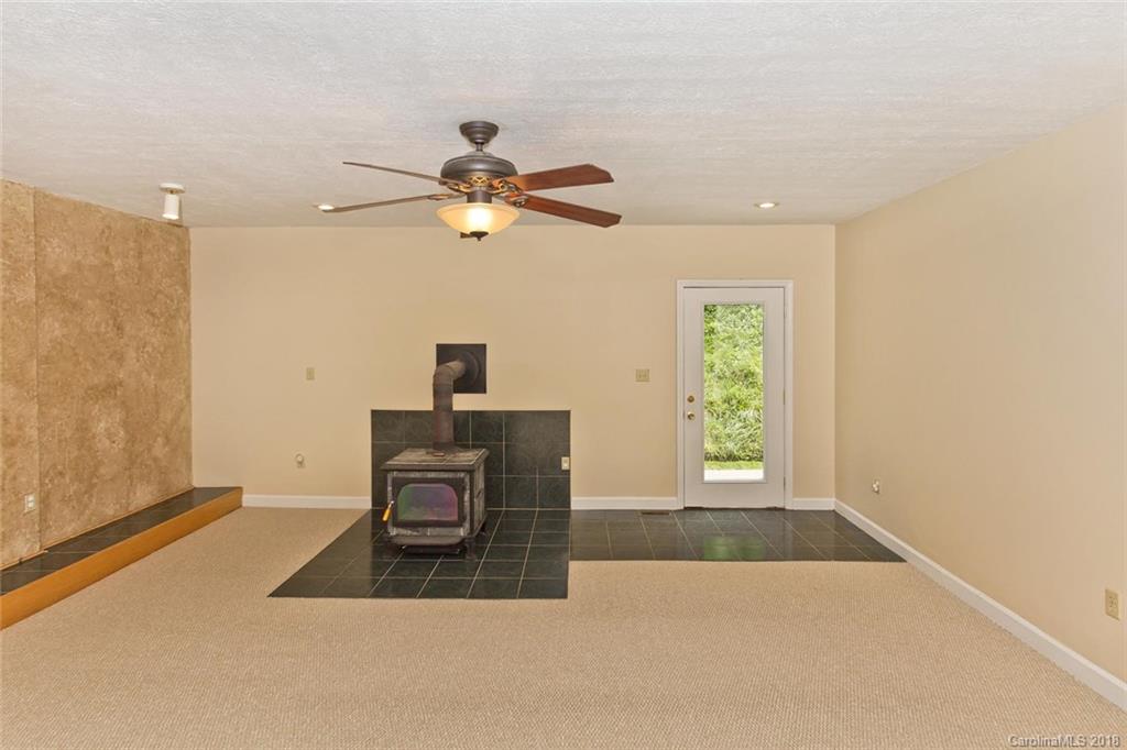 282 Fox Creek Road Mars Hill, NC 28754 - Photo 6 of 36 a view of a livingroom with a ceiling fan and a window