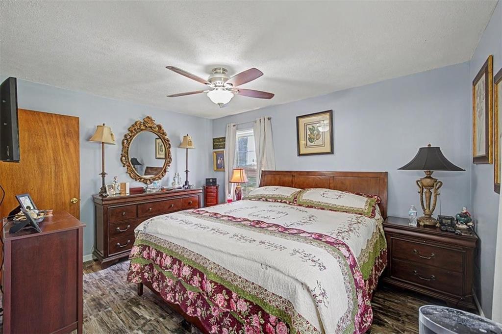 71 North Avery Road Northwest Rome, GA 30165 - Photo 24 of 42 a bedroom with a bed and wooden floor