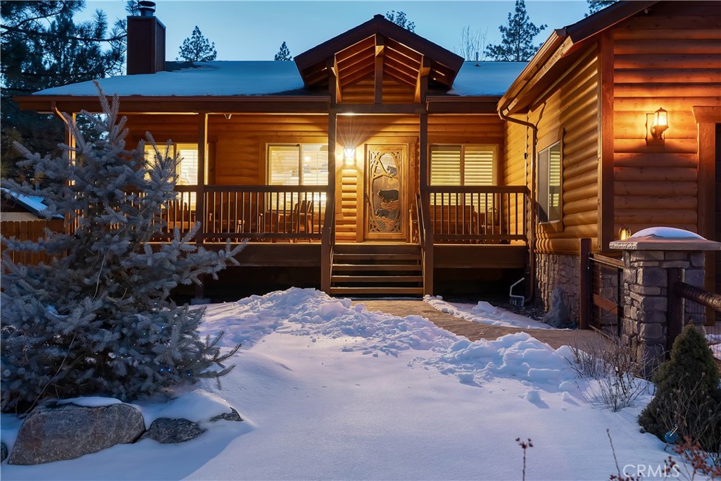 a backyard of a house with barbeque oven and outdoor seating