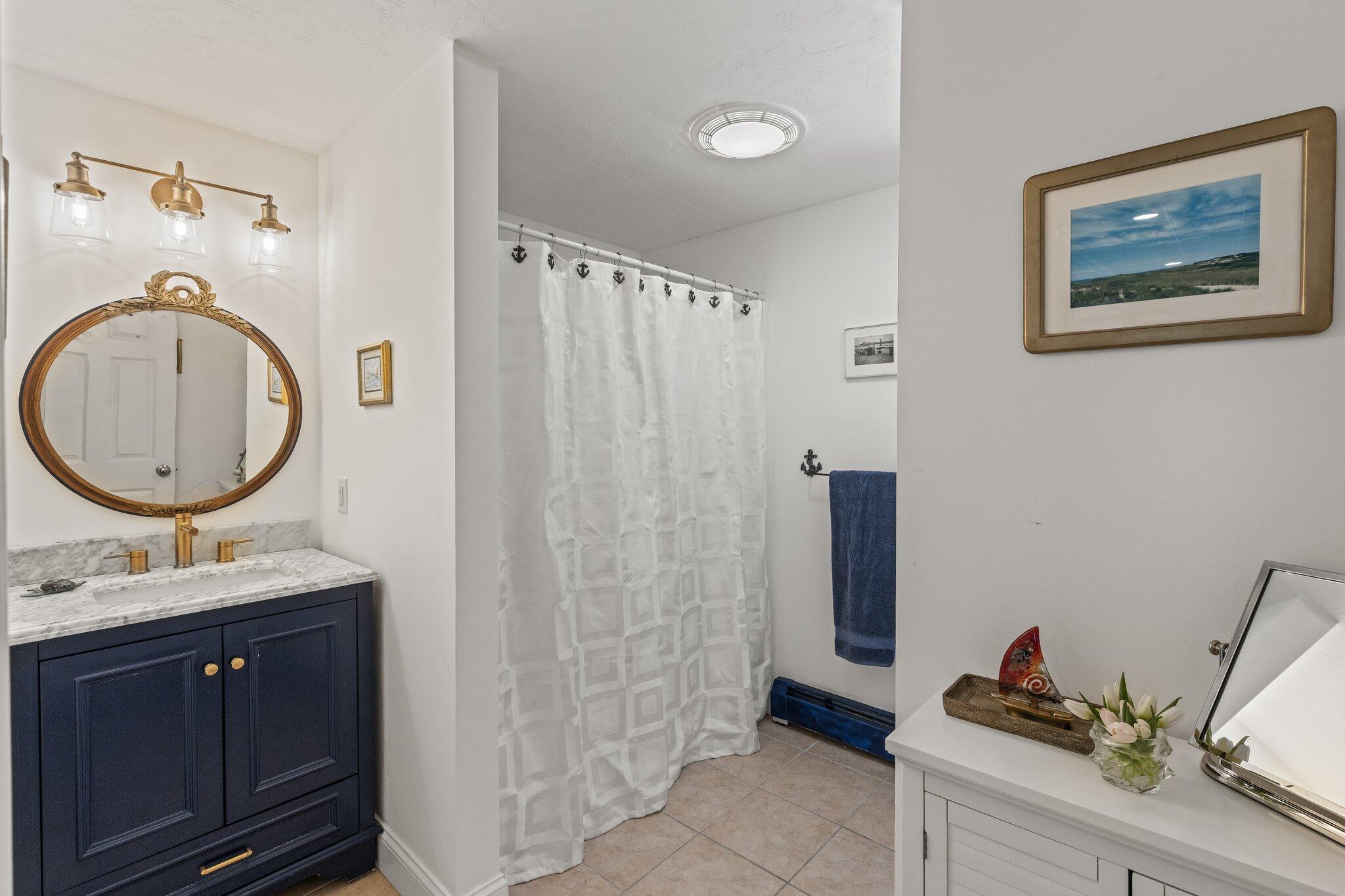 6 Short Lots Lane Truro, MA 02666 - Photo 17 of 63 a bathroom with a toilet a sink and a mirror