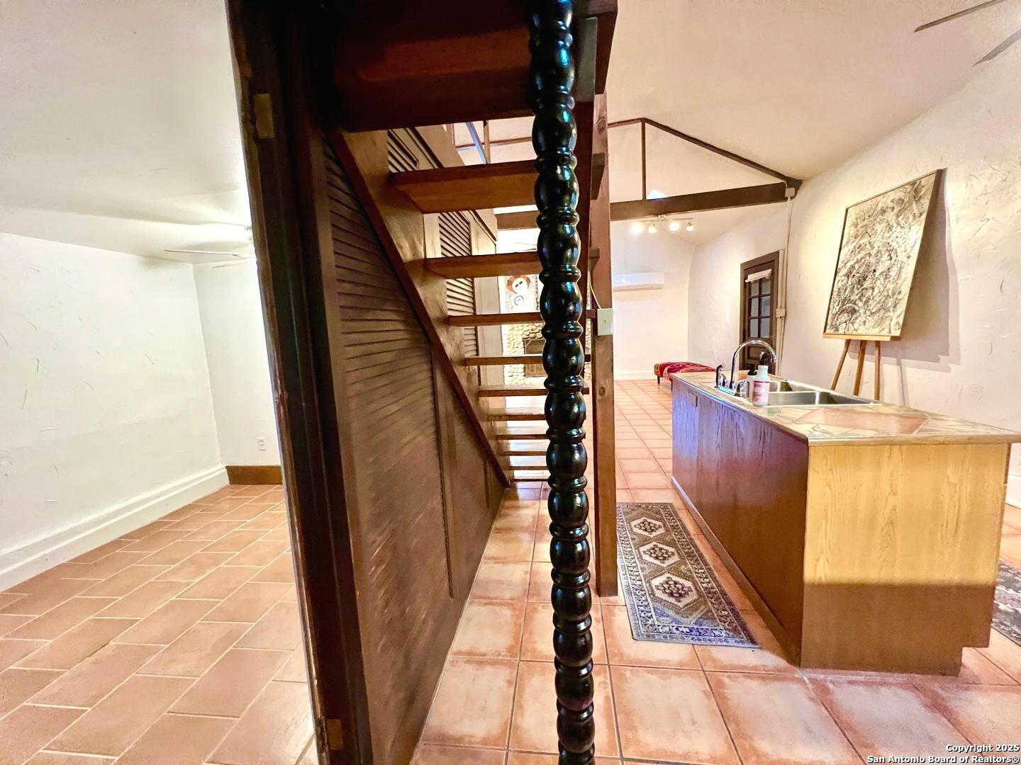 299 Fort Clark Road Brackettville, TX 78832 - Photo 17 of 45 a view of a hallway with wooden floor and stairs