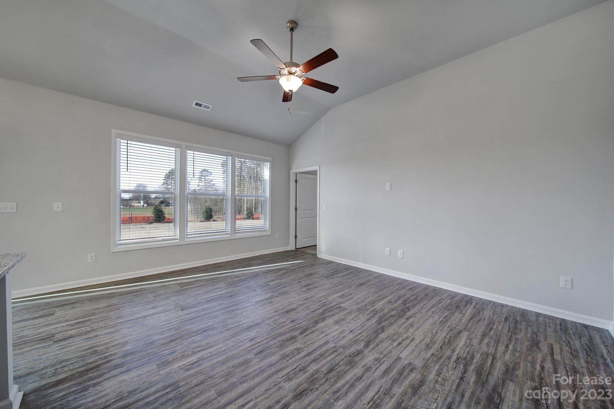 8201 Mccormick Street Terrell, NC 28682 - Photo 12 of 28 a view of an empty room with wooden floor and a window