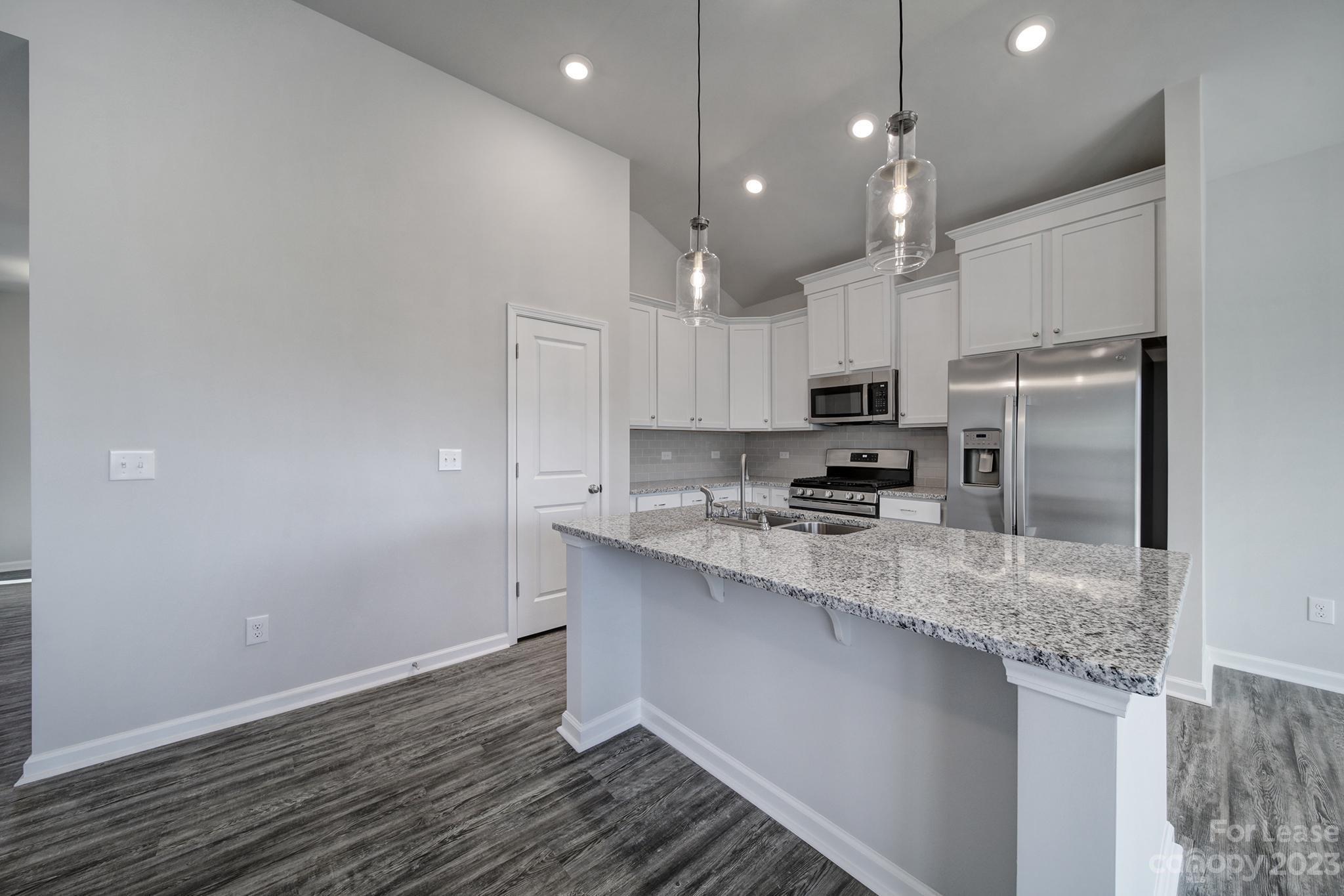 8201 Mccormick Street Terrell, NC 28682 - Photo 15 of 28 a kitchen with kitchen island a sink stainless steel appliances and cabinets
