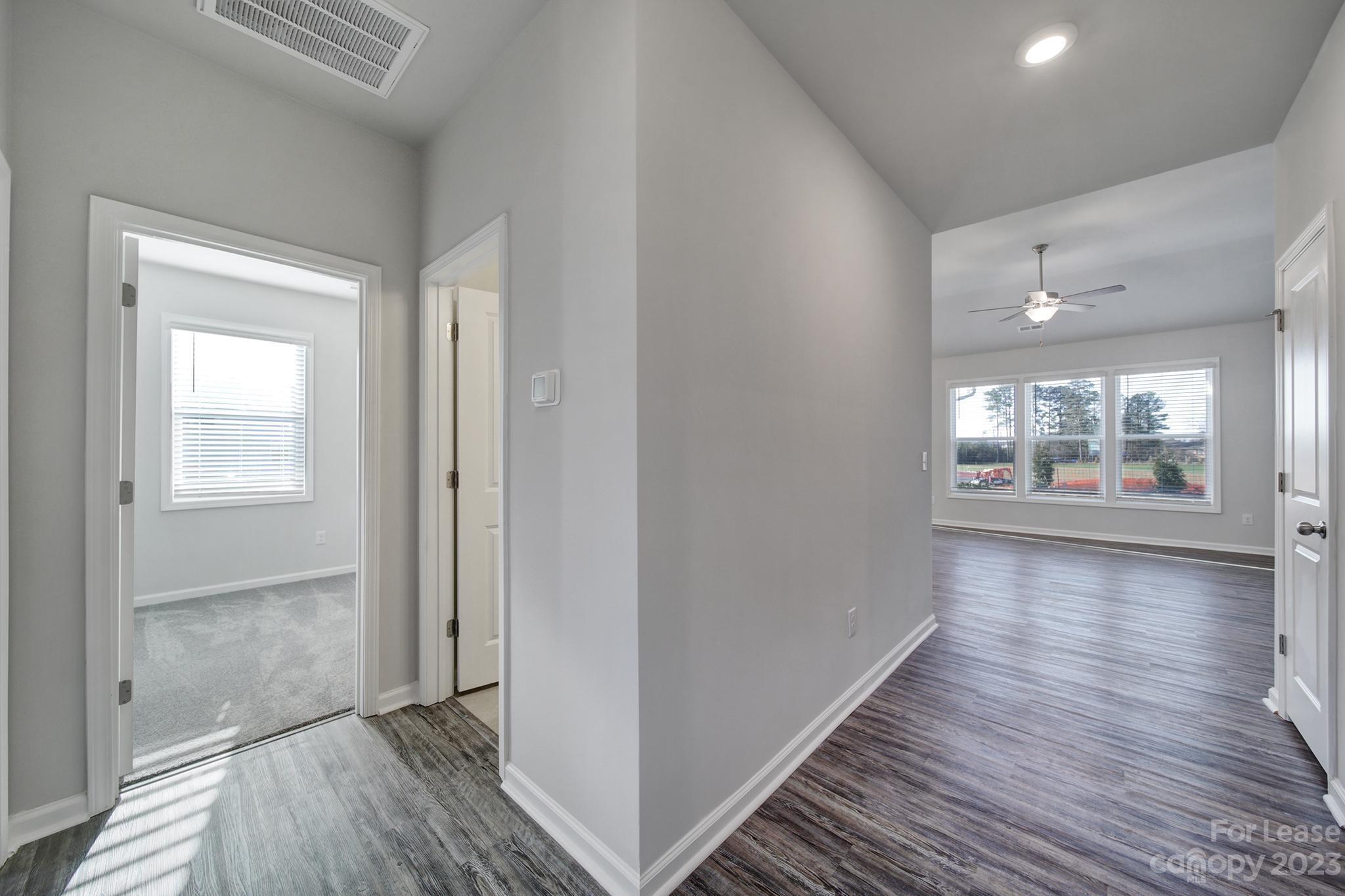 8201 Mccormick Street Terrell, NC 28682 - Photo 2 of 28 a view of an empty room with wooden floor and a window