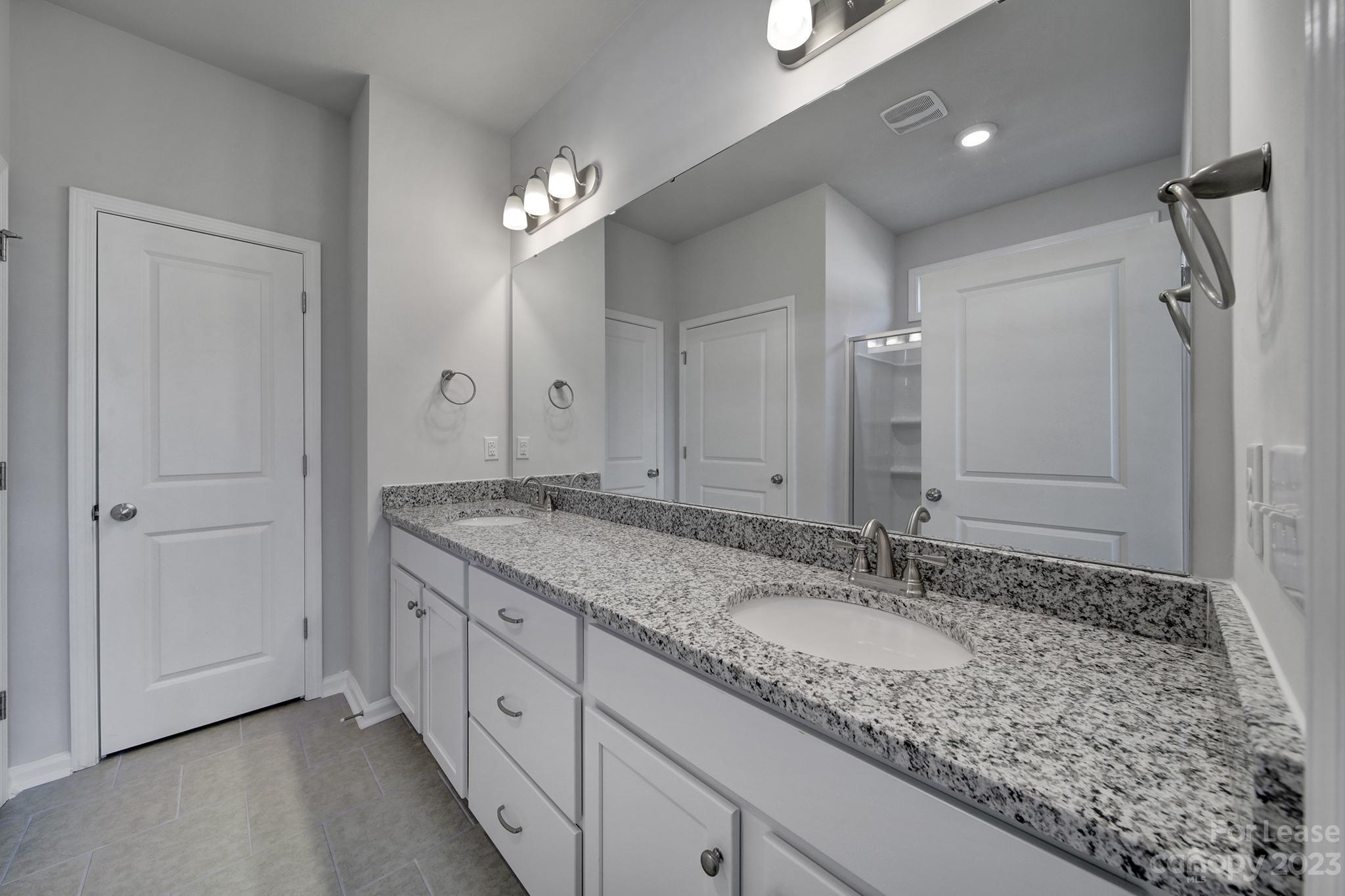 8201 Mccormick Street Terrell, NC 28682 - Photo 21 of 28 a bathroom with a granite countertop double vanity sink and a mirror