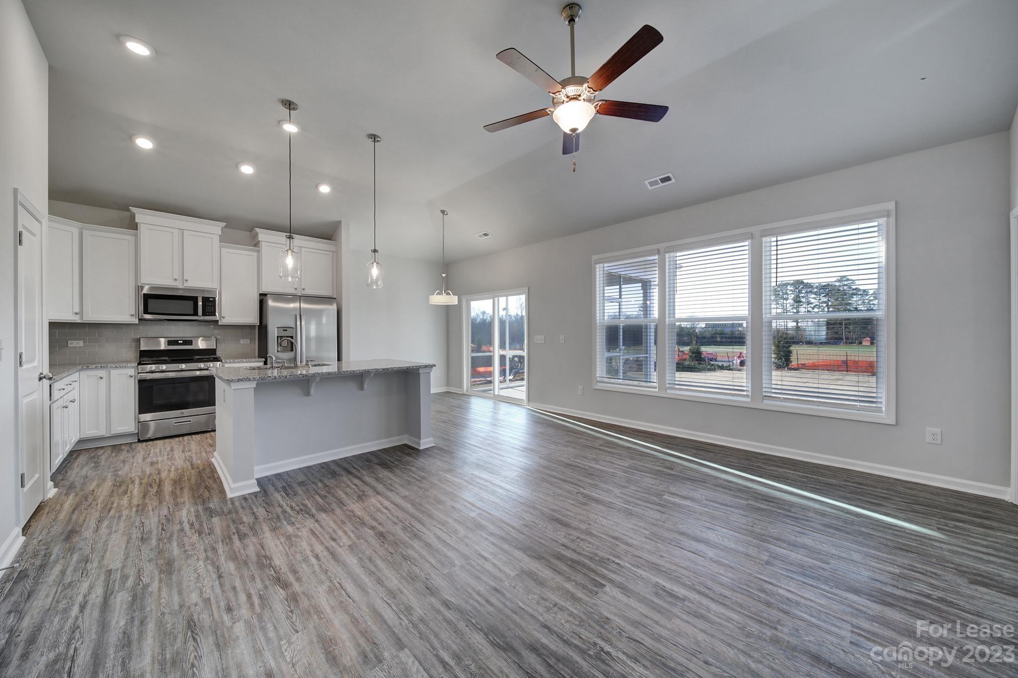 8201 Mccormick Street Terrell, NC 28682 - Photo 9 of 28 a large kitchen with stainless steel appliances kitchen island a large counter space a sink appliances and a large window