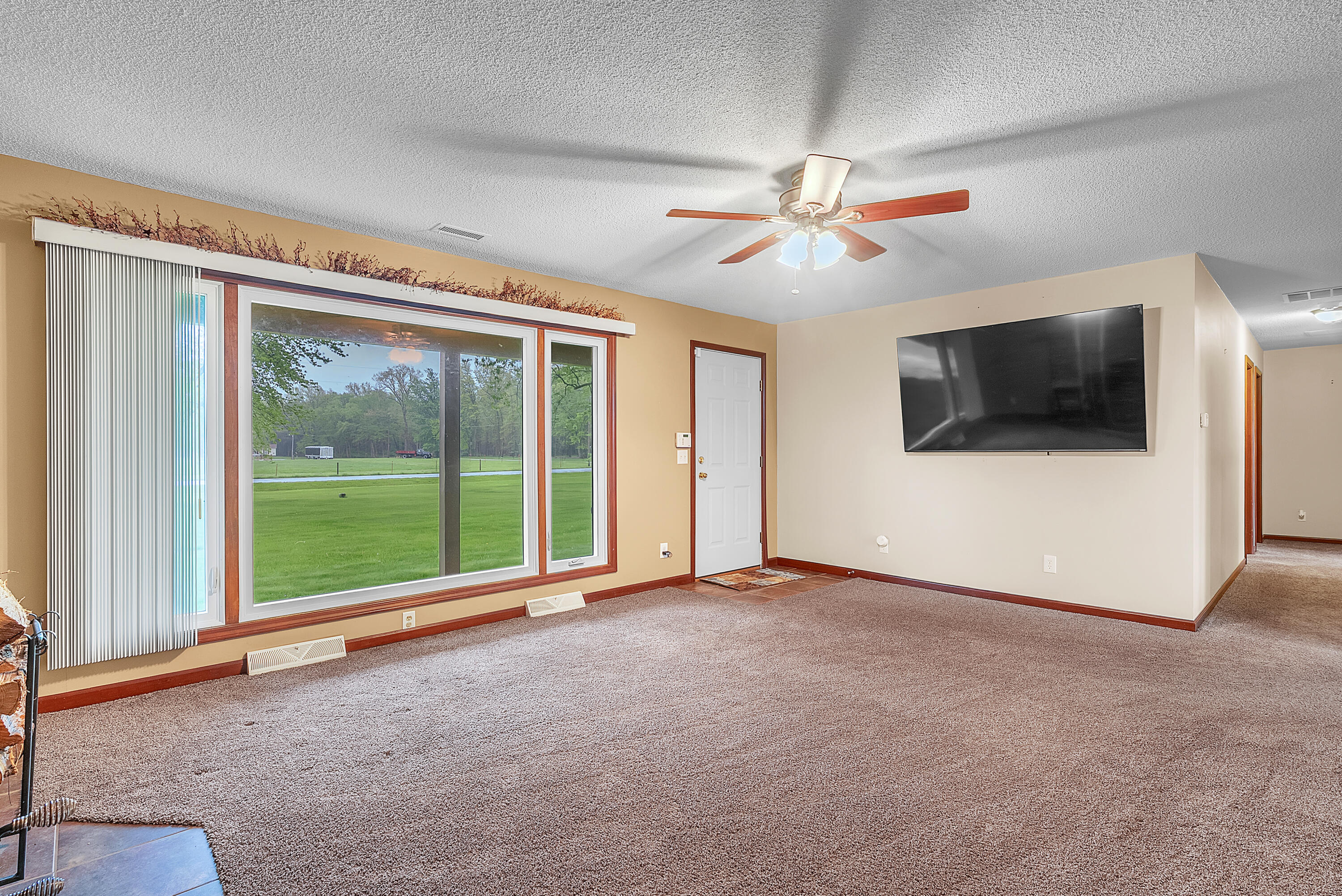 2204 South Meridian Road Morocco, IN 47963 - Photo 14 of 35 a view of an empty room with a window and a flat screen tv