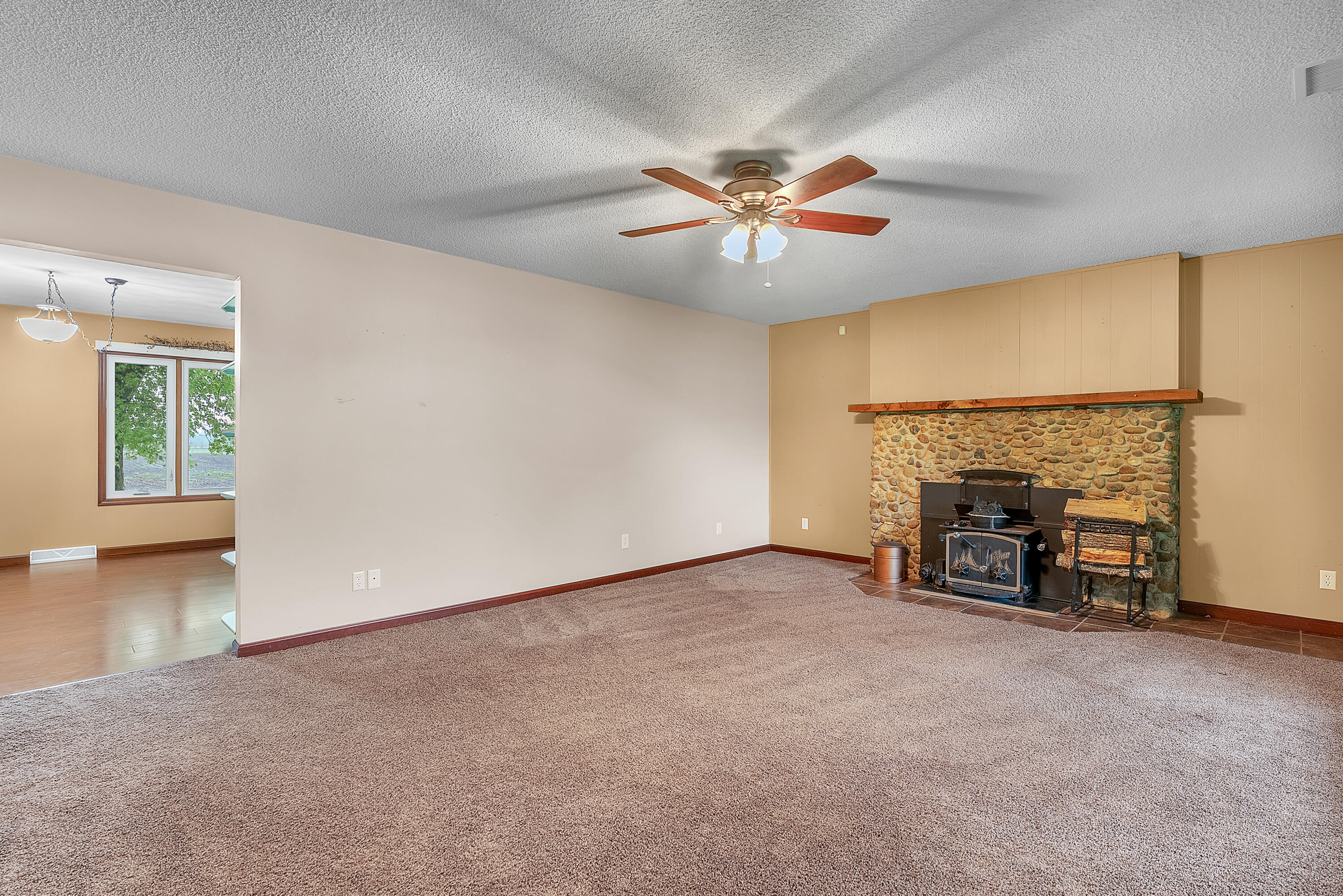2204 South Meridian Road Morocco, IN 47963 - Photo 16 of 35 an empty room with windows fireplace and fan
