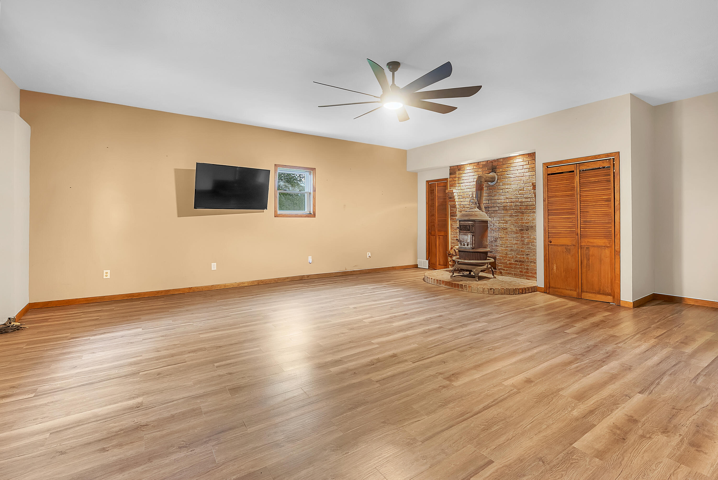 2204 South Meridian Road Morocco, IN 47963 - Photo 3 of 35 a view of empty room with wooden floor and fan
